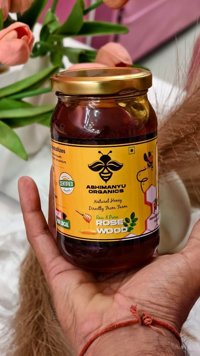 A jar of Abhimanyu Organics Rosewood honey held in hand